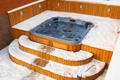 arctic spas hot tub in deck with snow